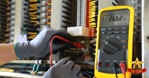 A gloved person uses a digital multimeter to measure voltage inside an electrical panel with