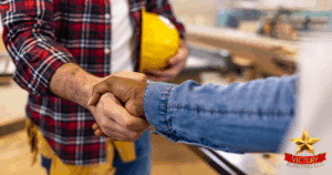 Two people shake hands indoors, one holding a yellow hard hat. The Victory Electric LLC logo appears